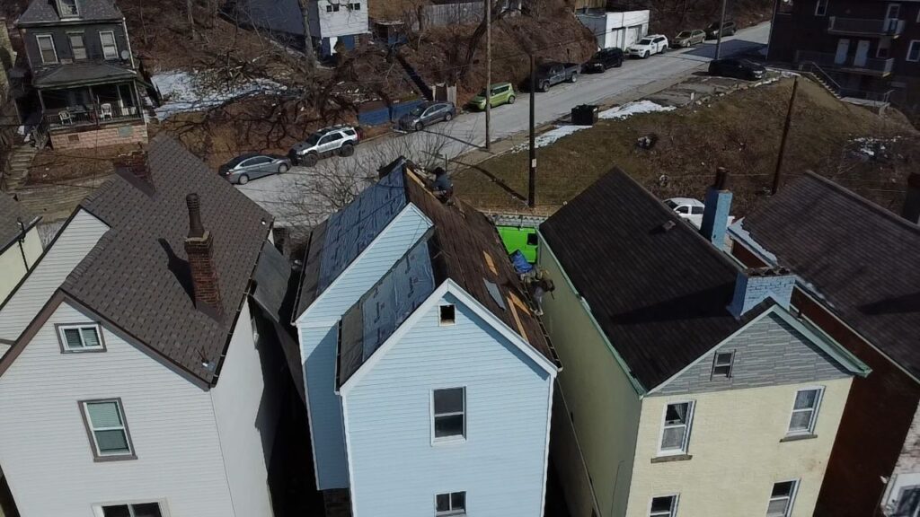 Aerial view of homes in Bridgeville, PA, showcasing roofing work in progress, highlighting residential architecture and neighborhood streets.