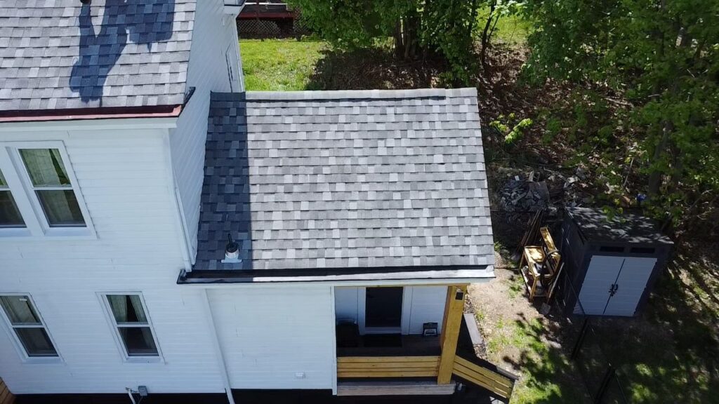 Aerial view of a residential home in Pittsburgh featuring a newly installed asphalt shingle roof, highlighting the roof's maintenance and upgrade potential for homeowners.