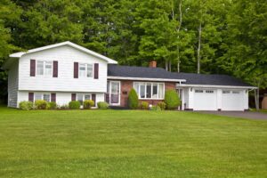 Split-level home in Pittsburgh with a well-maintained lawn, showcasing architectural features relevant to local roofing considerations.