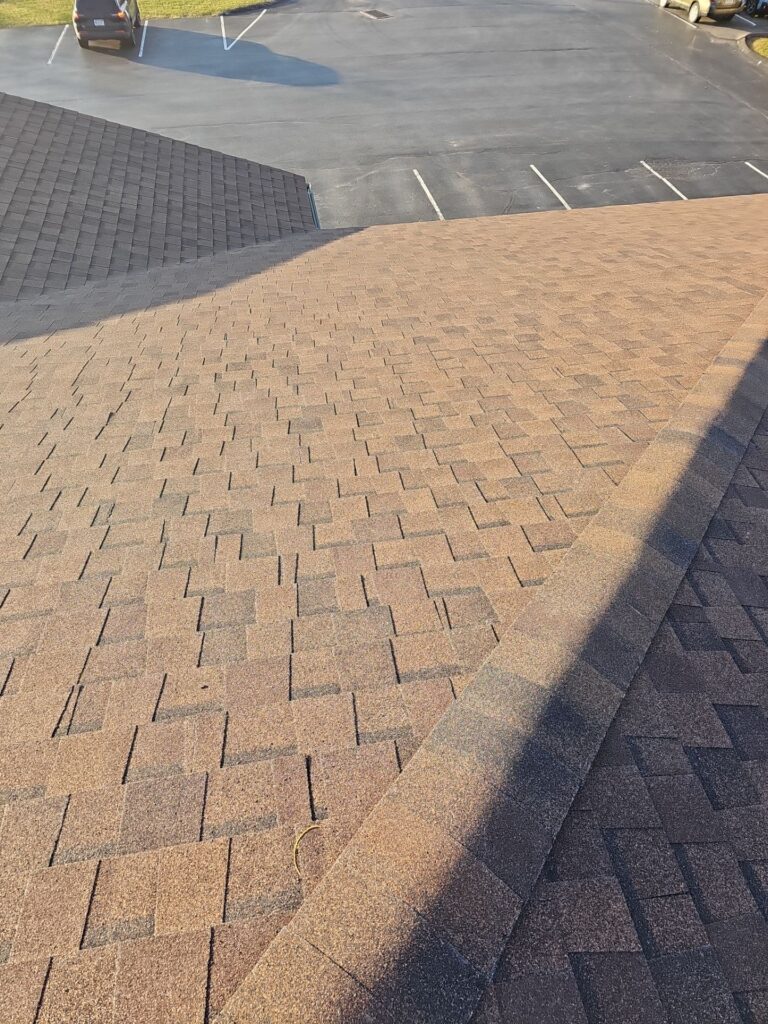 Roofing shingles on a sloped surface, showcasing architectural shingle design, relevant to roofing materials and maintenance in Pittsburgh.