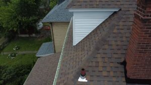Roofing details of a residential property in Mount Washington, PA, showcasing shingles, chimney, and adjacent siding, relevant to home improvement and roof maintenance tips.