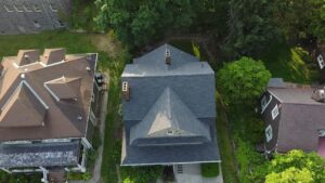 Aerial view of residential homes in Pittsburgh, showcasing a well-maintained roof, emphasizing the importance of roof repair and maintenance for homeowners.