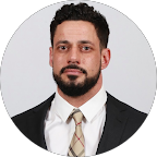 Professional portrait of a man in a suit and tie, representing Alan Construction, emphasizing commitment to quality roofing services in Pittsburgh.