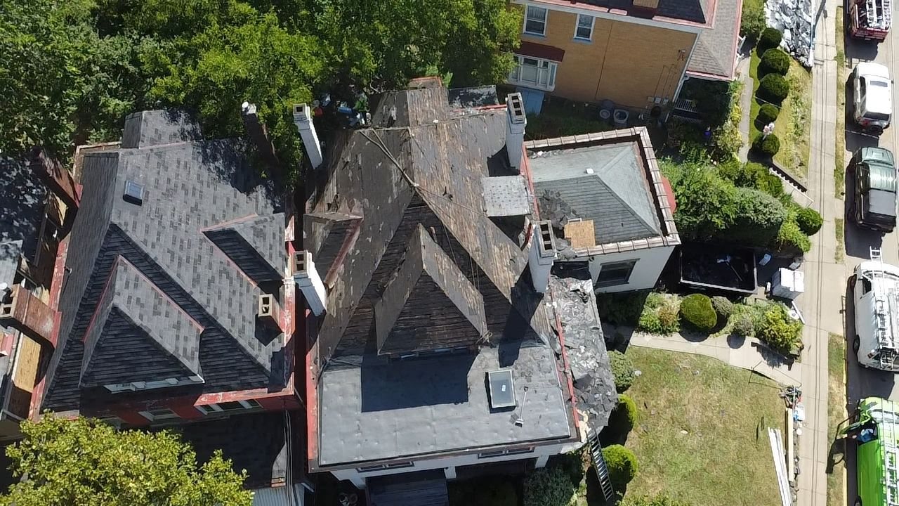 Drone view of an old weathered roof before replacement in Pittsburgh, Alan Construction