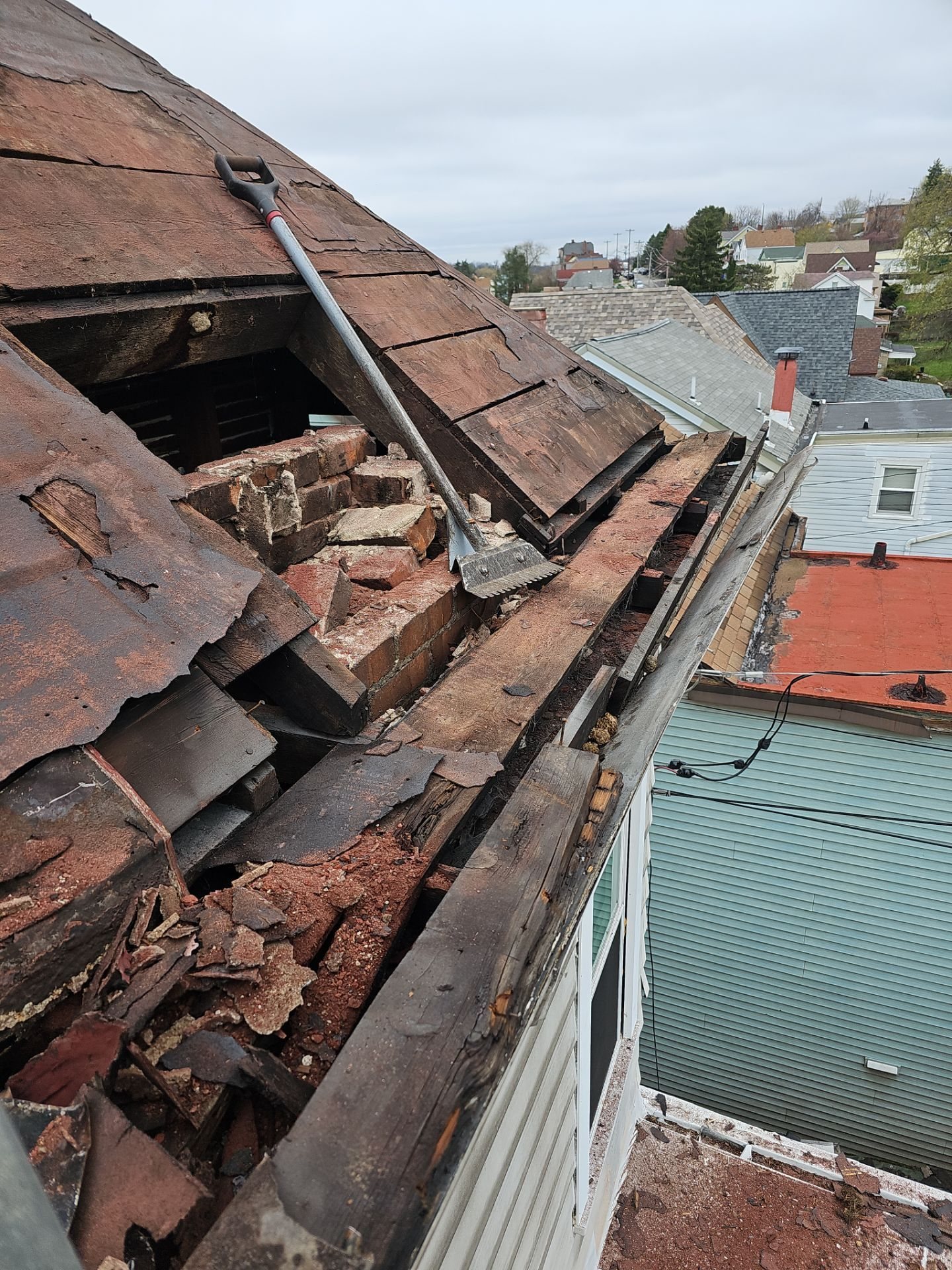 Rotted roof boards and broken old shingles at a roof edge in Pittsburgh, Alan Construction
