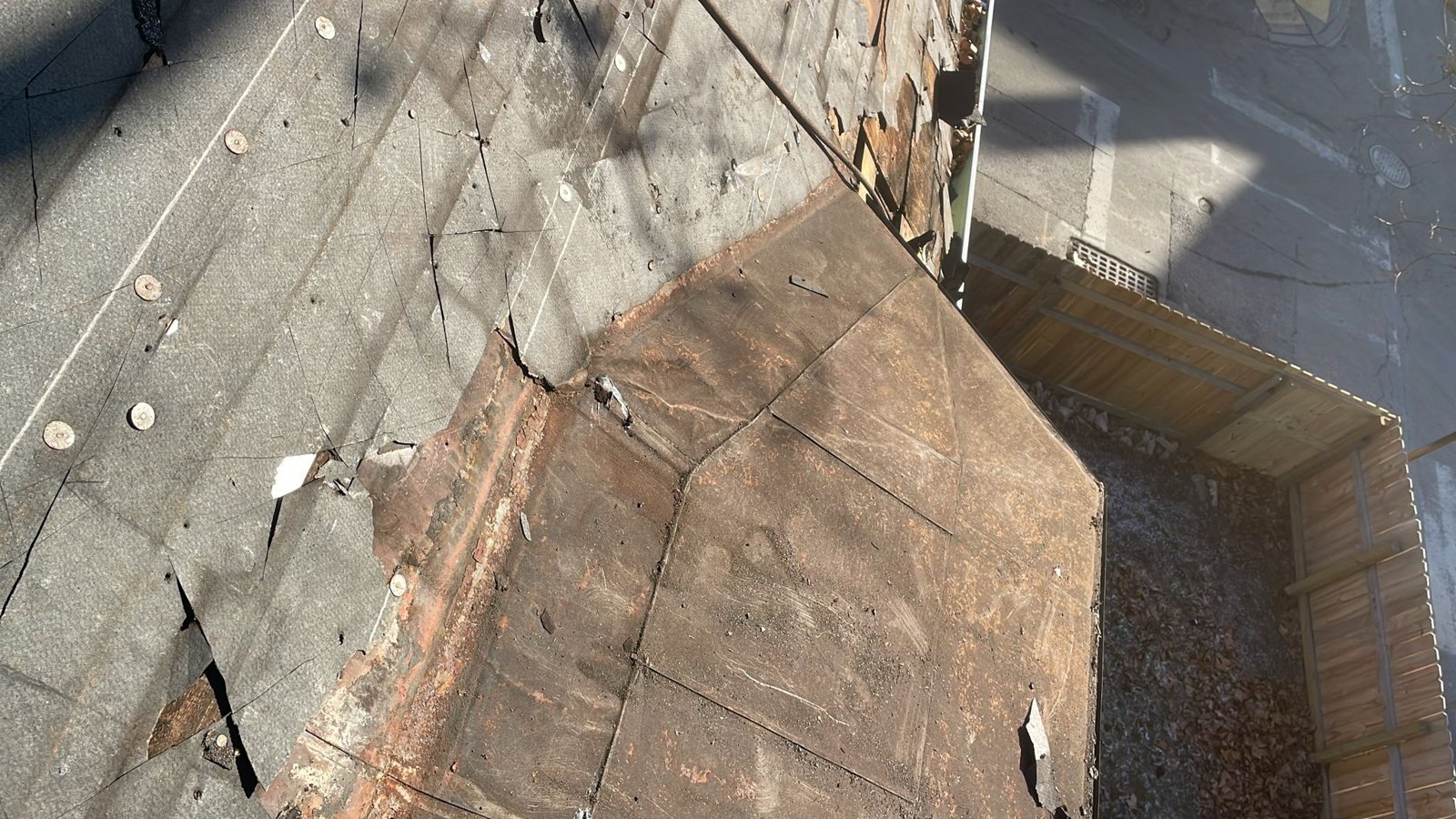 Worn rolled roofing and old flashing on a low slope roof in Pittsburgh, Alan Construction