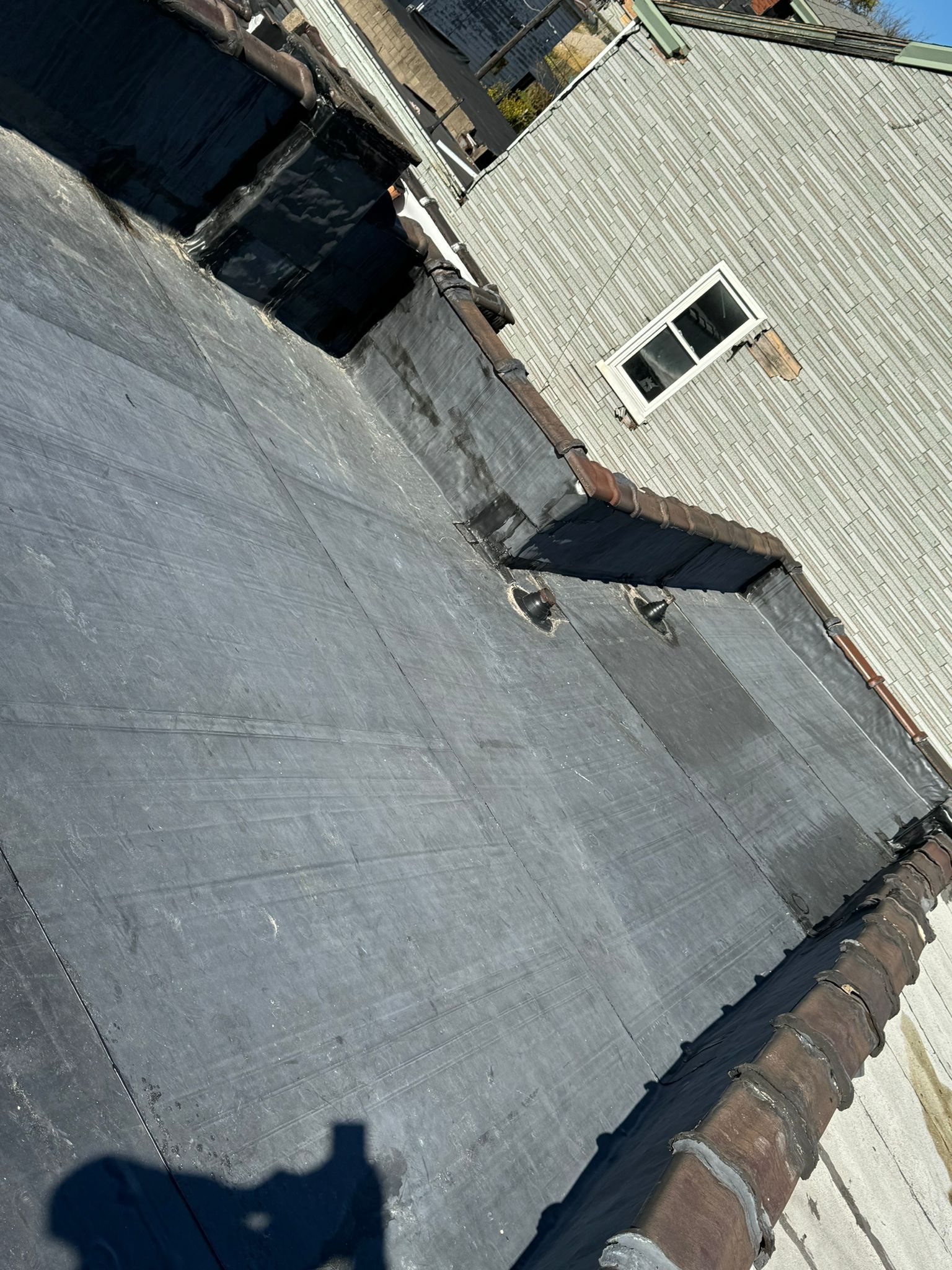 Black flat roof membrane meeting a sided wall in Pittsburgh, Alan Construction