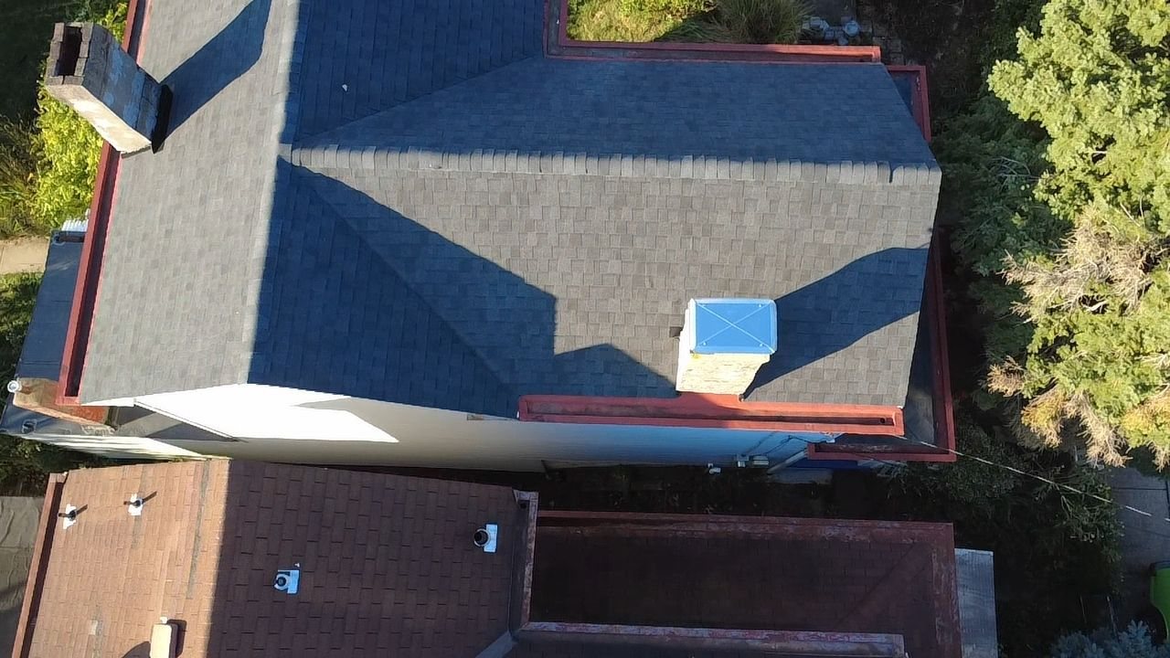 Drone view of a new dark gray shingle roof with red trim in Bethel Park, Alan Construction