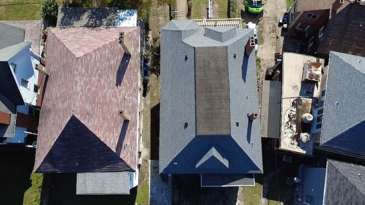 Overhead drone view of a new gray hip roof with a flat center in Pittsburgh, Alan Construction