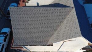 Close drone view of new gray architectural shingles on a gable roof in Pittsburgh, Alan Construction