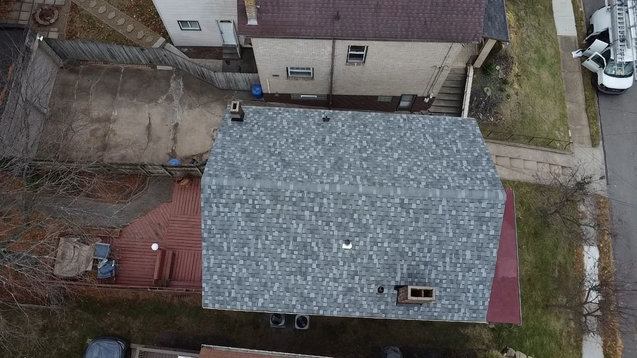 Drone view of a new gray shingle roof on a house in Pittsburgh, Alan Construction