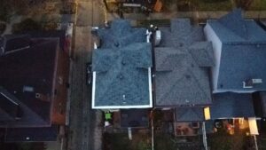 Top down drone view of finished gray roofs with white trim in Pittsburgh, Alan Construction