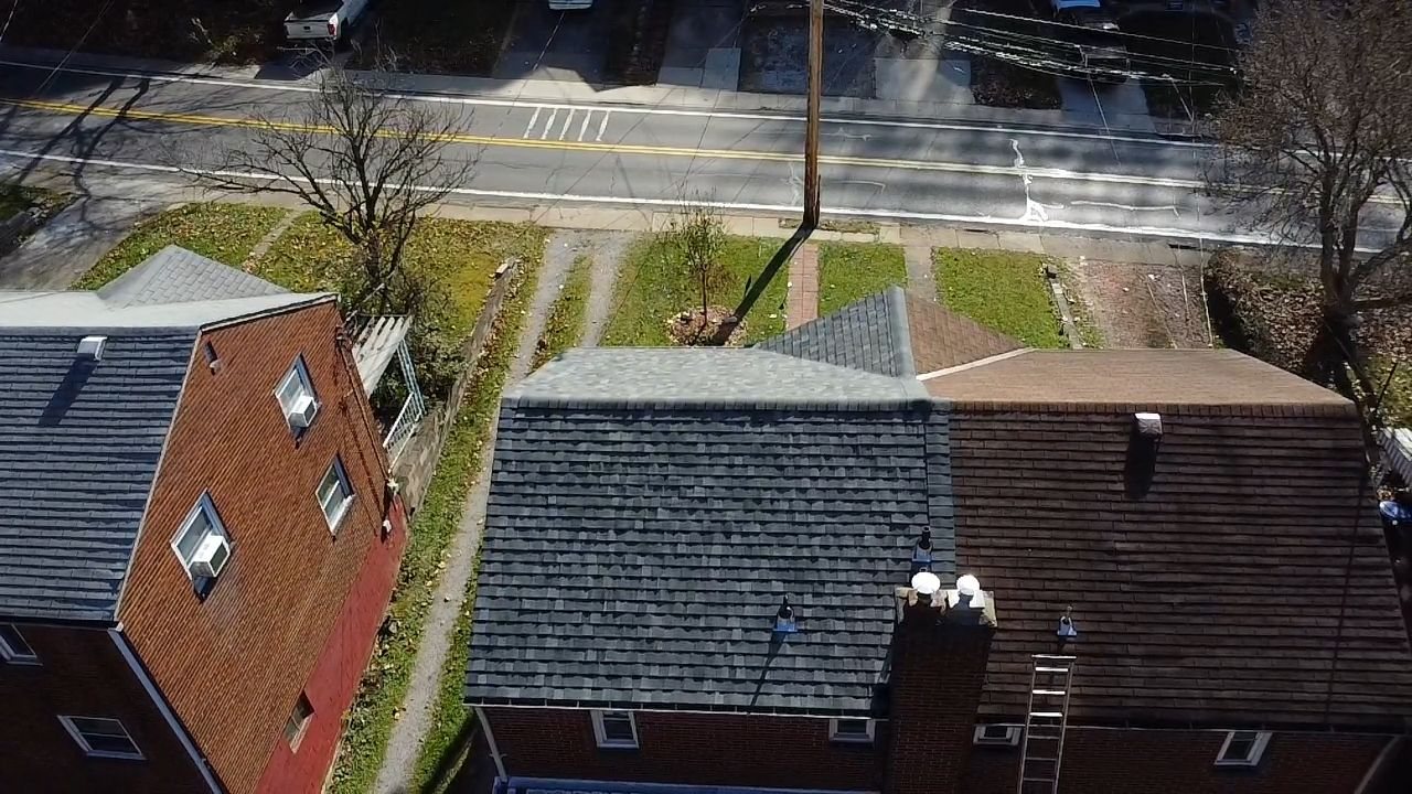 Drone view of a house with a finished dark roof and chimneys in Pittsburgh, Alan Construction