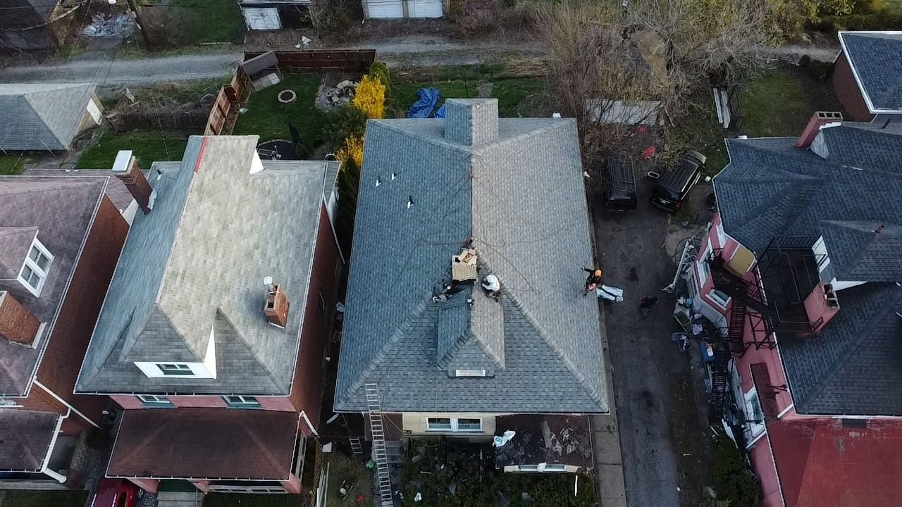 Aerial view of two finished gray shingle roofs side by side in Pittsburgh, Alan Construction