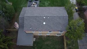 Drone view of a new gray roof on a long ranch house in Pittsburgh, Alan Construction