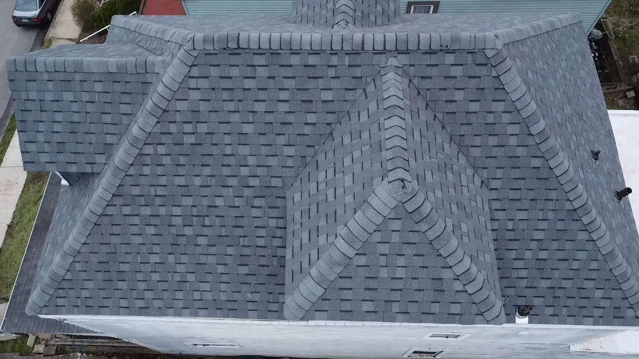 Close aerial view of a new hip roof with ridge caps in Pittsburgh, Alan Construction