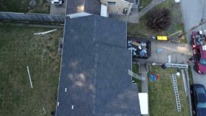 Drone view of a completed gray shingle roof on a house in Pittsburgh, Alan Construction