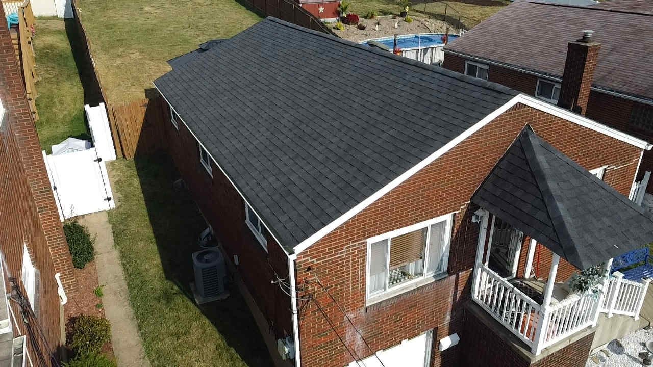 Drone view of a new dark shingle roof on a brick home in West Mifflin, Alan Construction