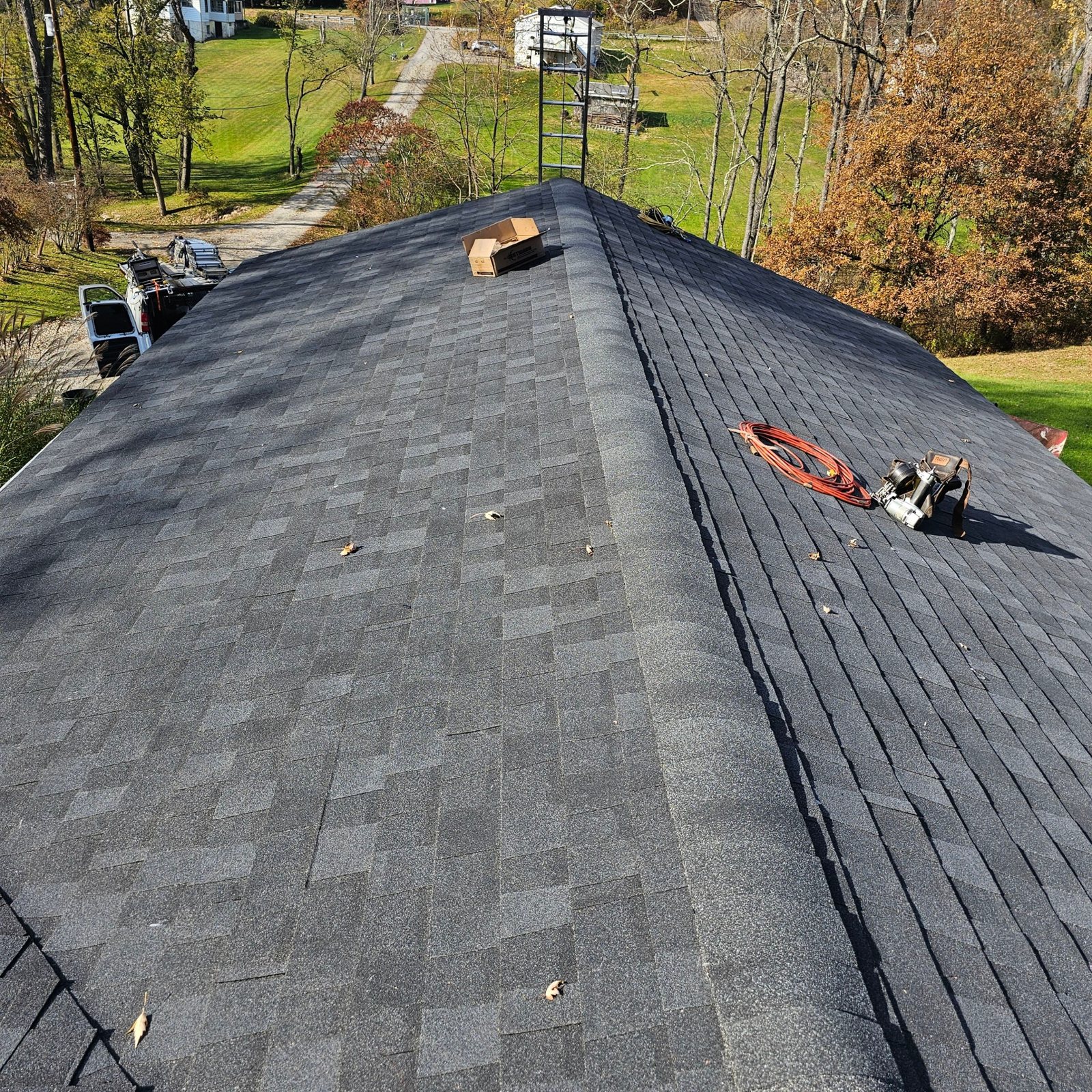 New gray architectural shingles meeting at the roof ridge in Natrona Heights, Alan Construction