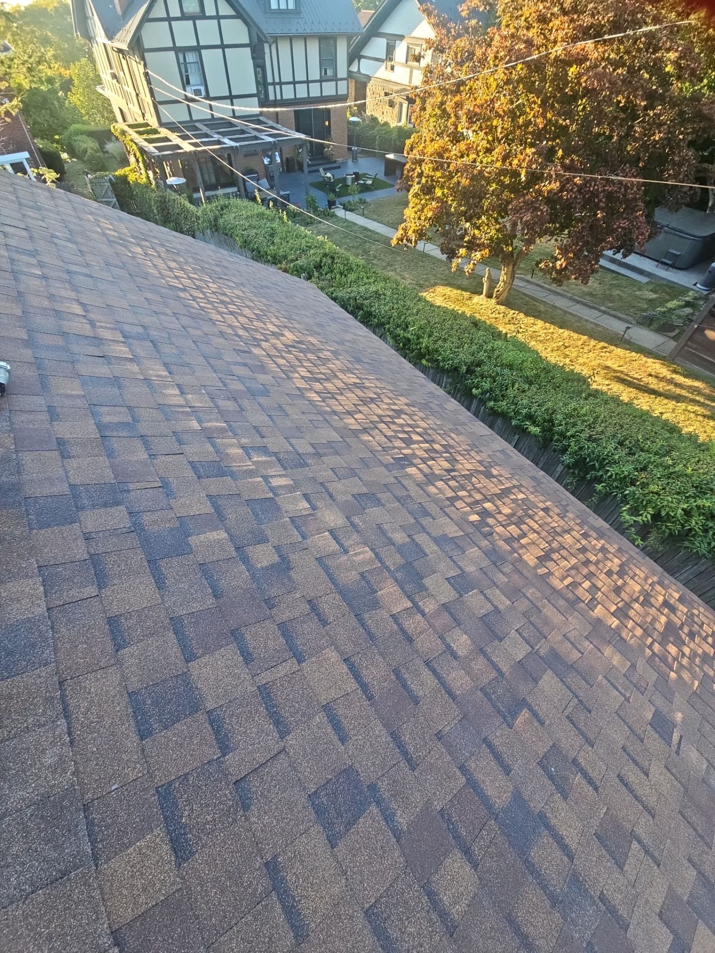 Long slope of new brown blend architectural shingles in warm light in Pittsburgh, Alan Construction