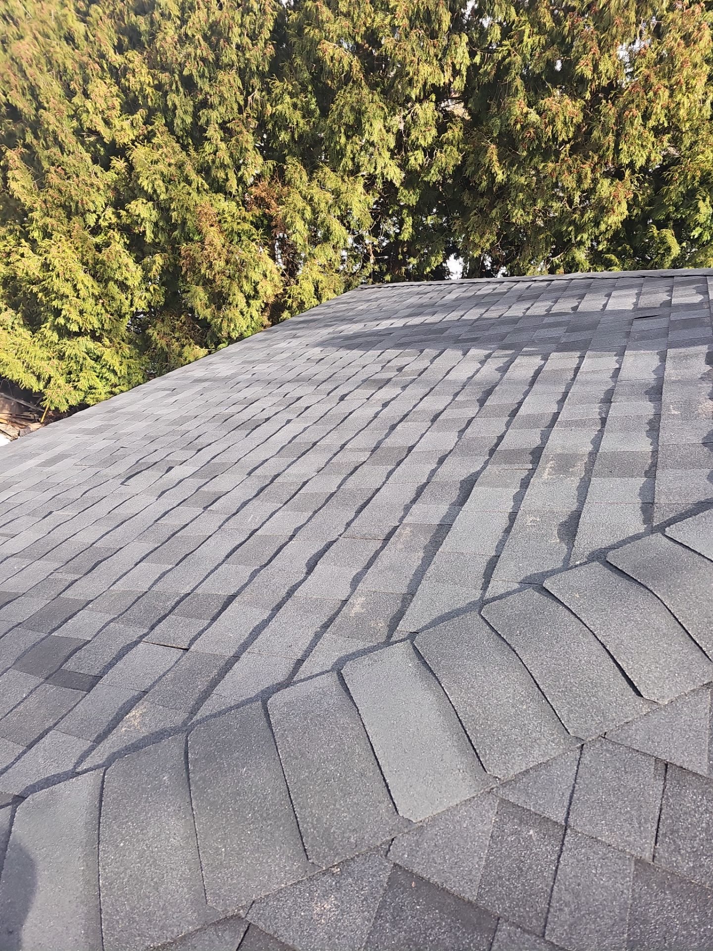 New gray shingles meeting at a hip ridge in Pittsburgh, Alan Construction