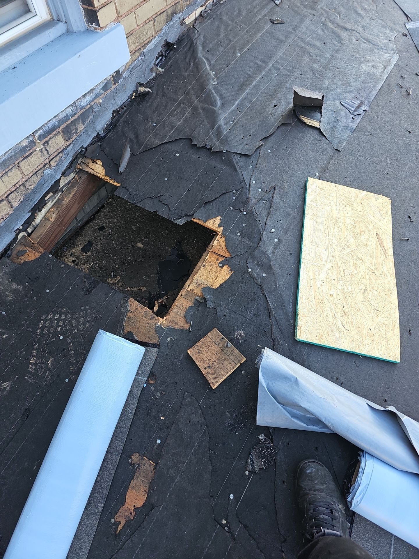 Rotted deck section cut out on a torn off low slope roof in McKeesport, Alan Construction