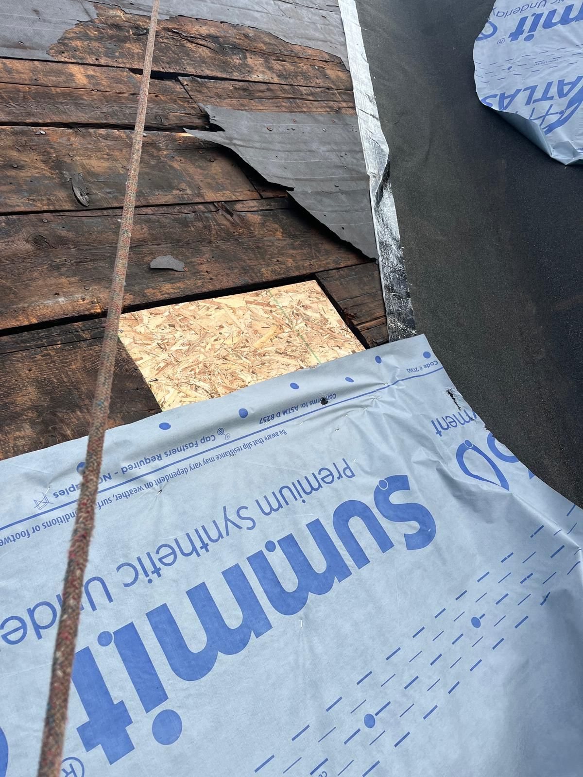 New plywood patch in old plank decking next to underlayment in Pittsburgh, Alan Construction