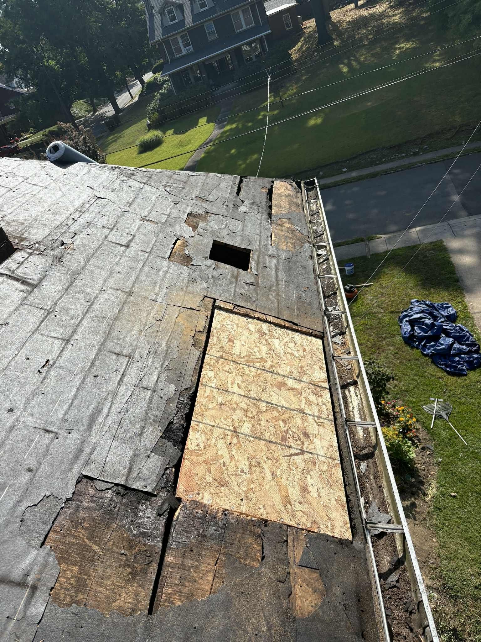 Rotted roof boards with a new plywood patch near the gutter in Pittsburgh, Alan Construction