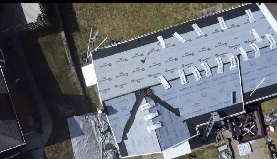 Drone view of a roof partly shingled over white underlayment in Pittsburgh, Alan Construction