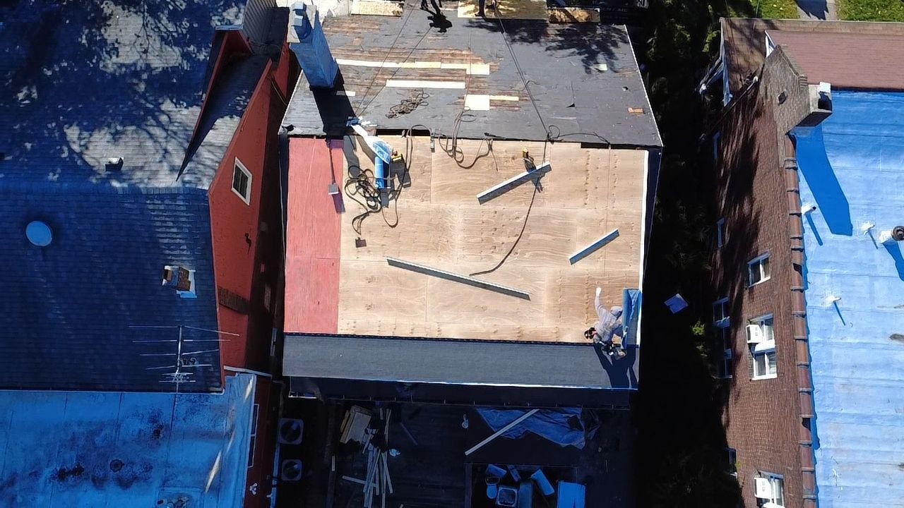 Drone view of a row house roof stripped to the decking in Pittsburgh, Alan Construction