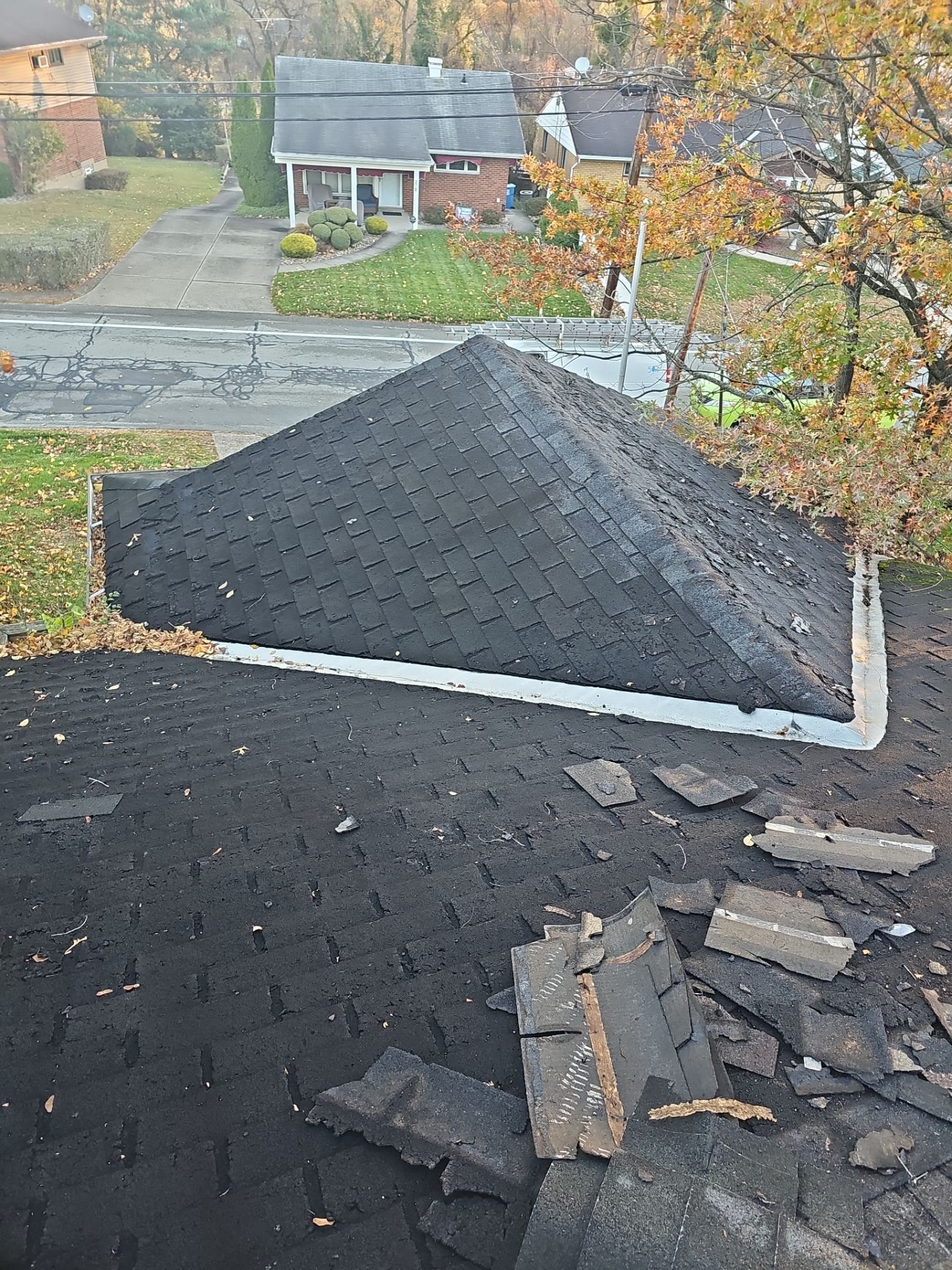 Torn up old shingles and debris on a hip roof in Pittsburgh, Alan Construction