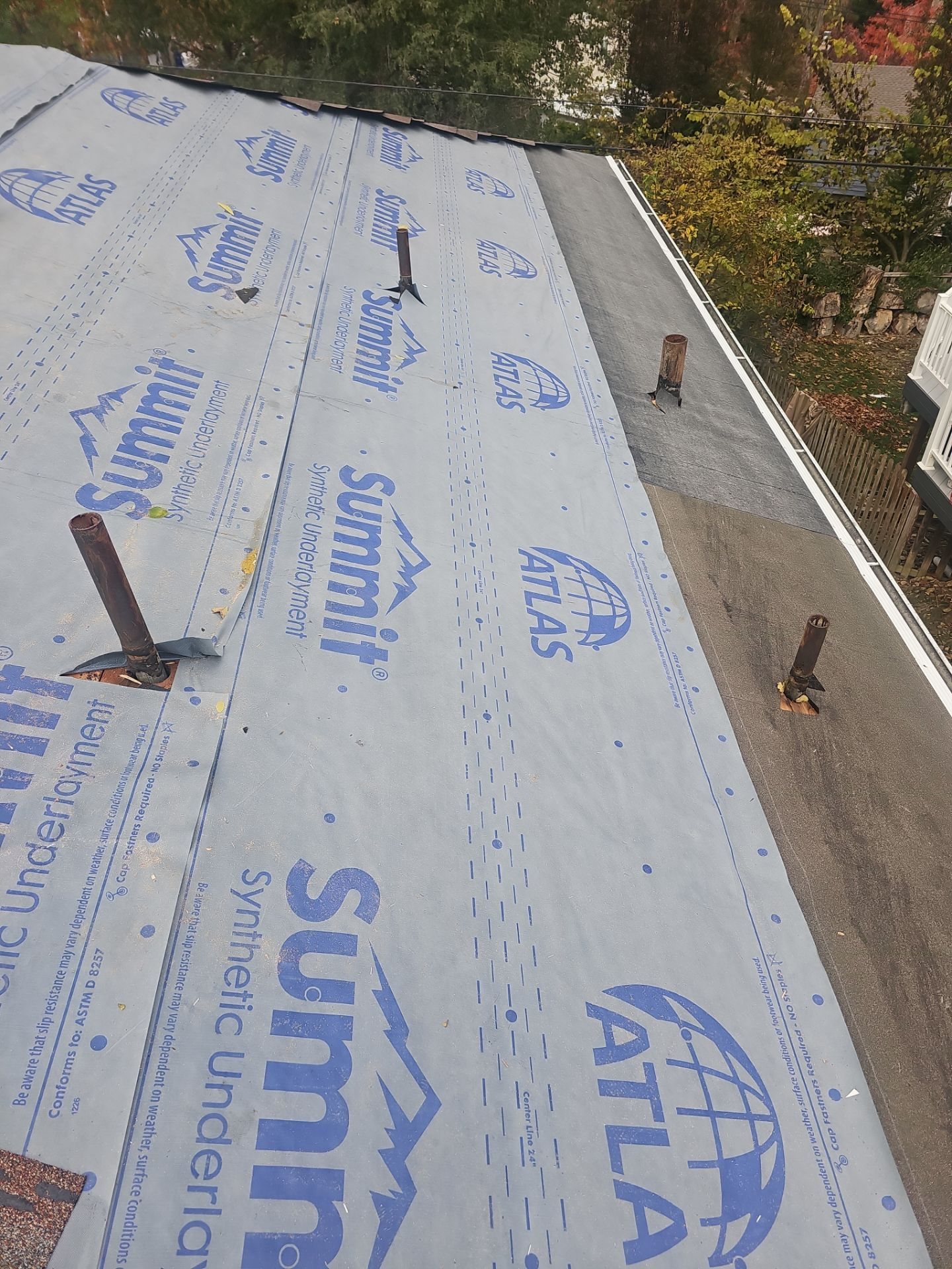 Synthetic underlayment fully covering a low slope roof with pipe vents in Pittsburgh, Alan Construction