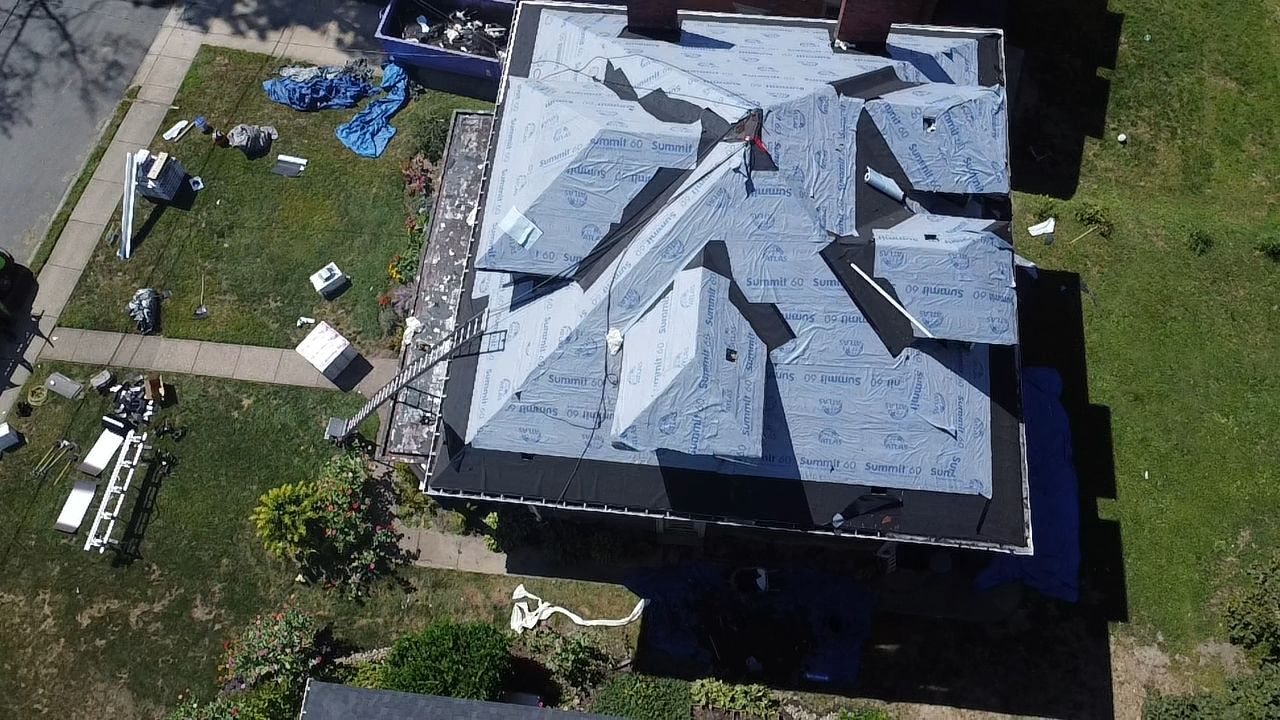 Drone view of a complex hip roof wrapped in underlayment in Pittsburgh, Alan Construction