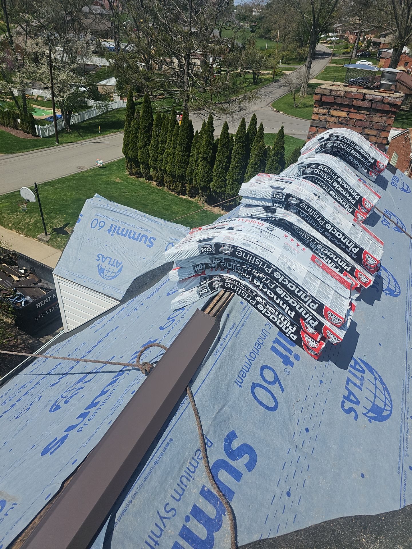 Synthetic underlayment over hips and ridges seen from the roof peak in Pittsburgh, Alan Construction