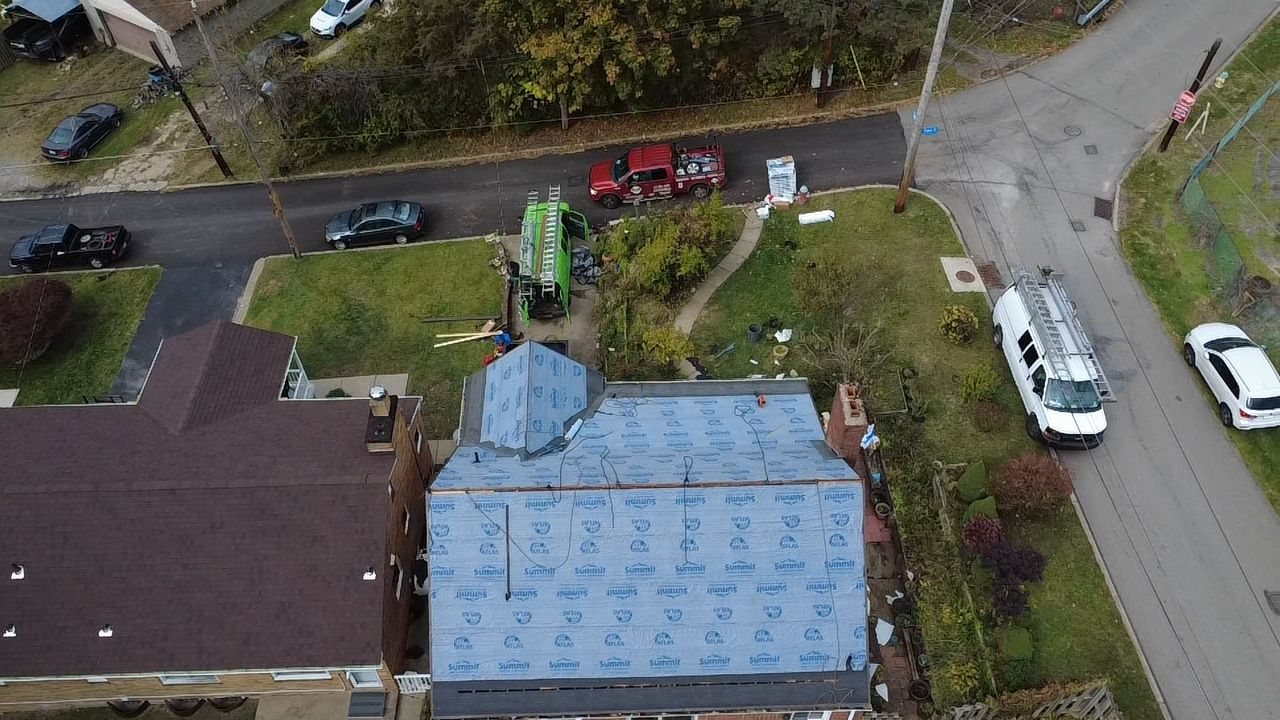Drone view of a roof covered in blue synthetic underlayment in Pittsburgh, Alan Construction