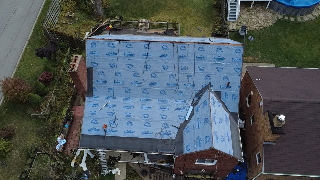 Aerial view of blue underlayment over a whole roof in Pittsburgh, Alan Construction