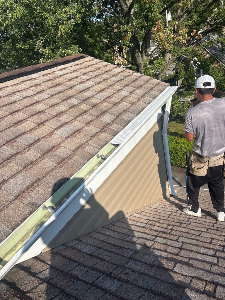 Crew installing gutters and trim