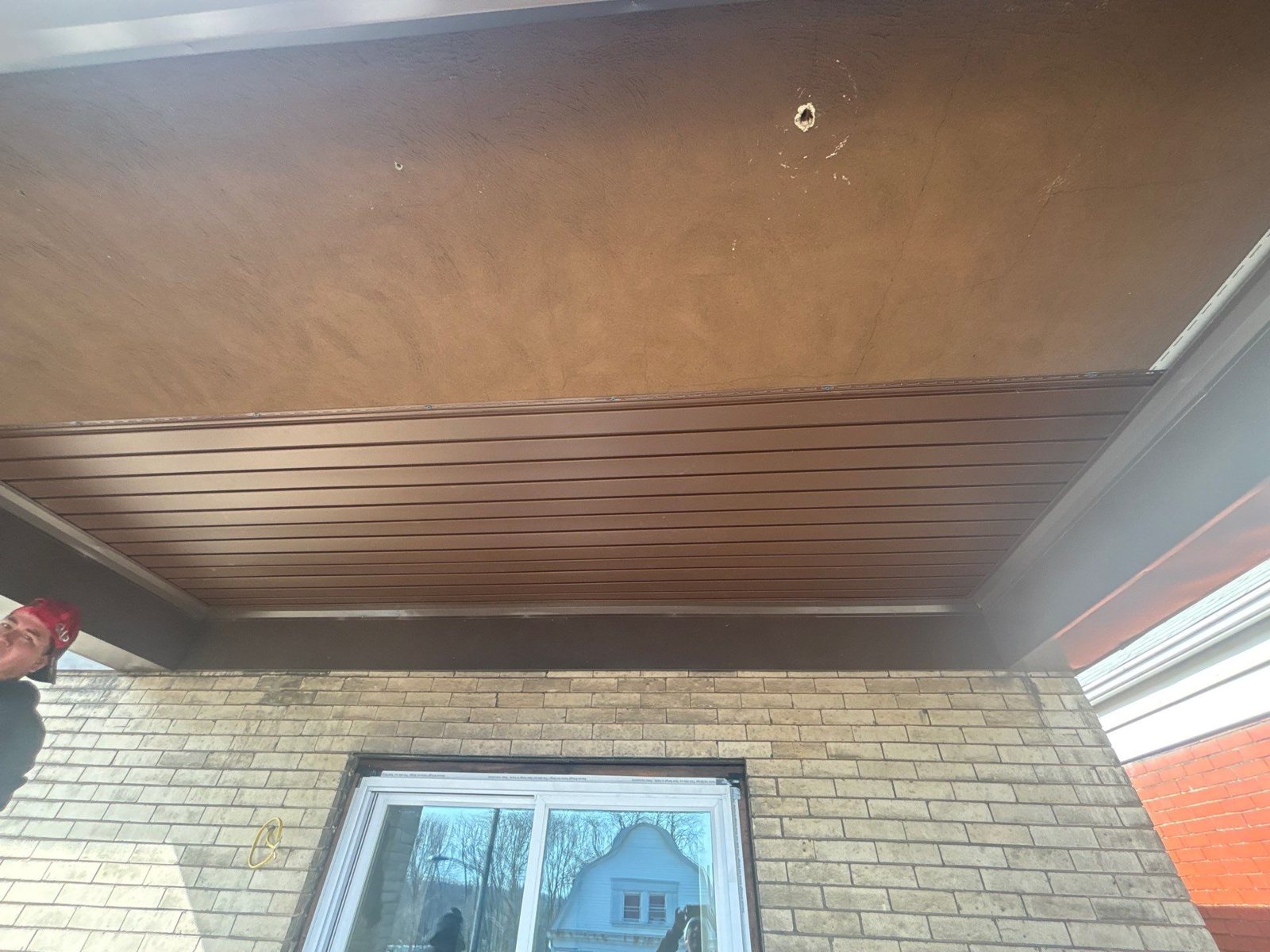 Porch ceiling with new soffit panels above a window in Pittsburgh, Alan Construction