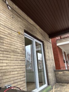 New sliding glass door on a brick upper porch in Pittsburgh, Alan Construction