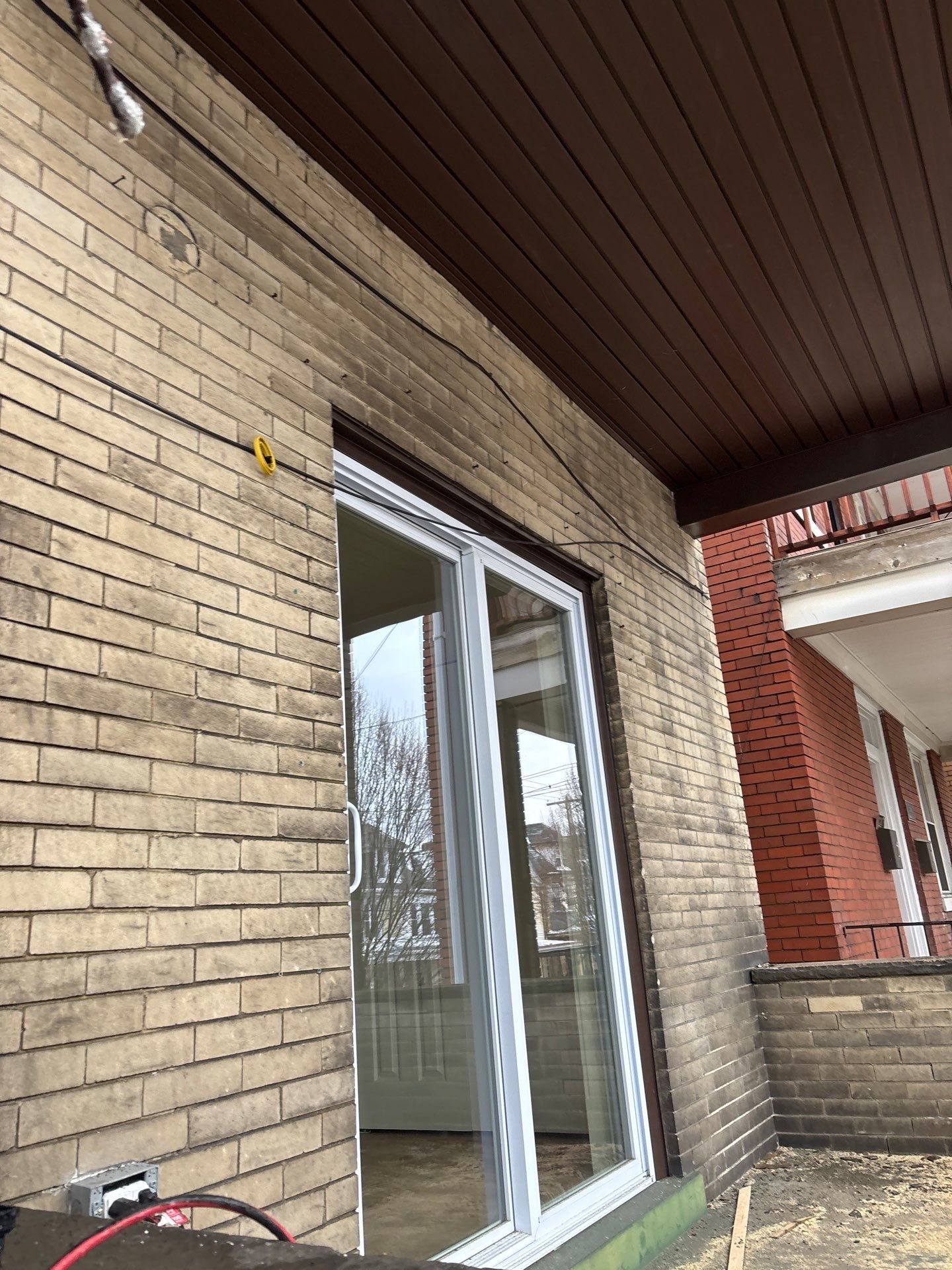 New sliding glass door on a brick upper porch in Pittsburgh, Alan Construction