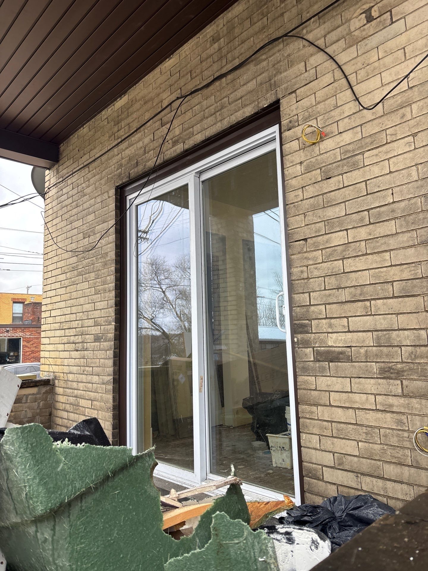 New sliding door installed in a brick wall on a porch in Pittsburgh, Alan Construction