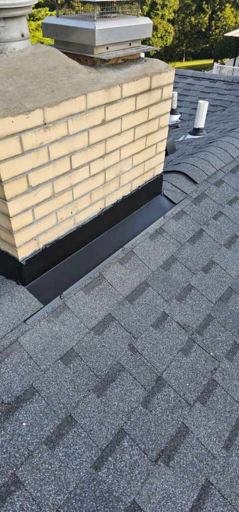 New step and counter flashing at a brick chimney in Bethel Park