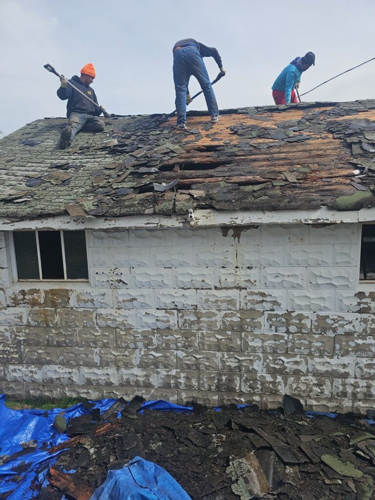 Old shingles coming off a Brookline garage roof