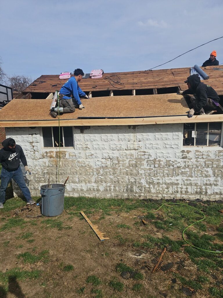 Crew tearing off the old garage roof in Brookline