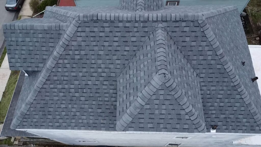 New hip roof on a Carrick home beside neighboring roofs