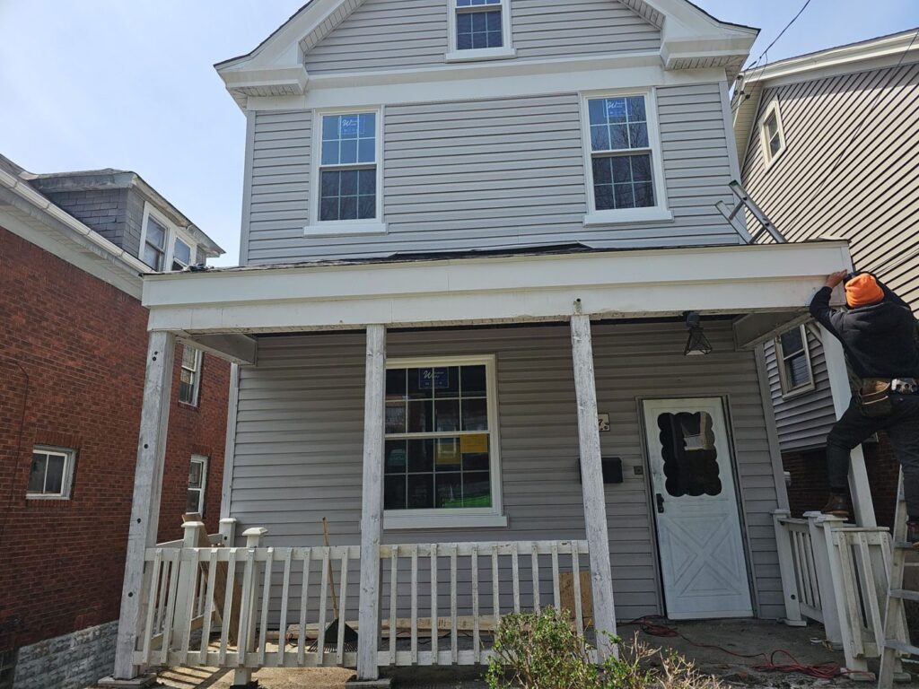 Crew working the porch roof on a Dormont home