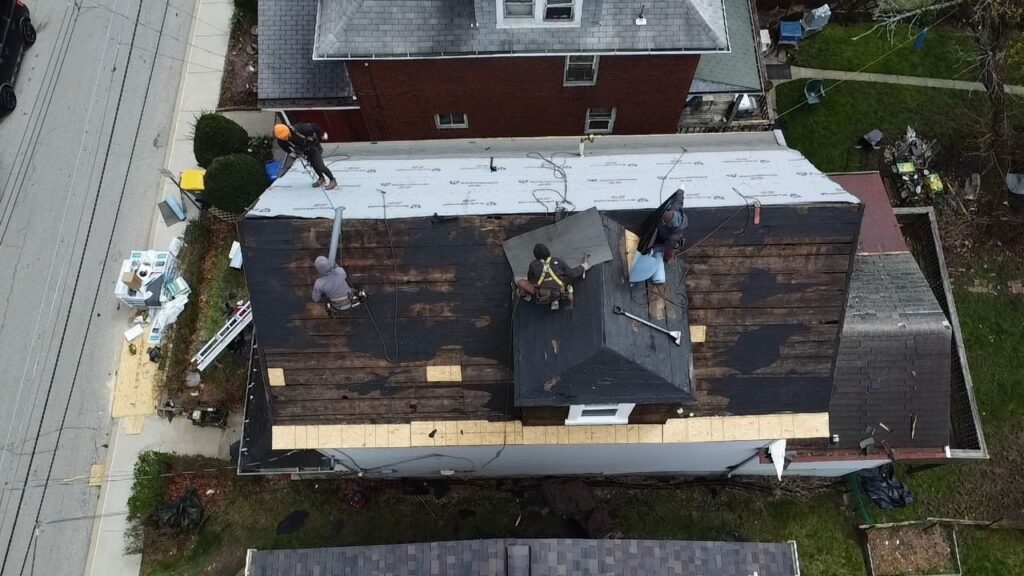 Crew working the low slope rear section of a Dormont roof