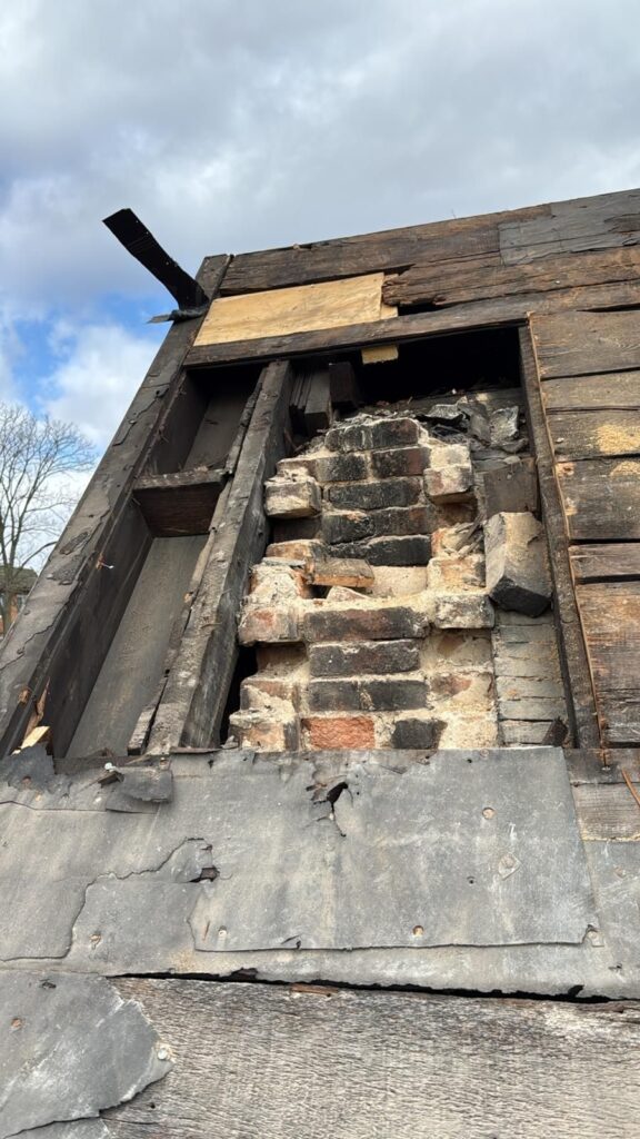Original board decking and old chimney flashing found during a Dormont tear off