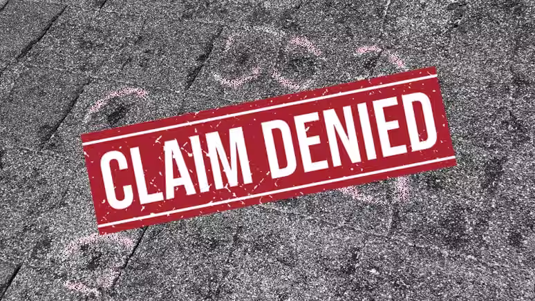 Claim denied banner over asphalt shingles with chalk circles marking possible hail damage
