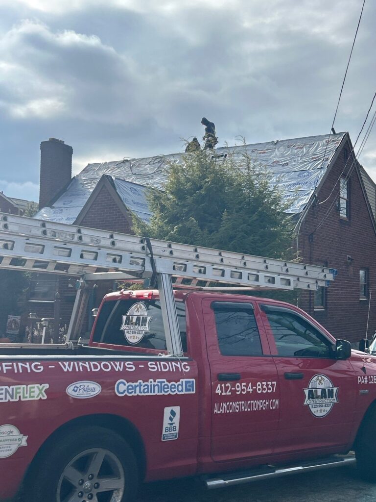 Alan Construction truck outside a Whitehall roof replacement